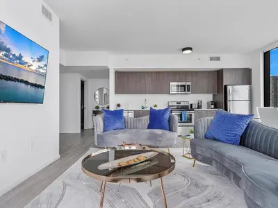 a living room with a couch and a table at X Lounge VI-Premium Corner Residence in Miami