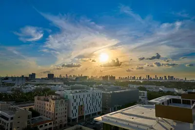 a view of a city with the sun in the sky at Skyline Studio at Roney Palace - 1429 in Miami Beach