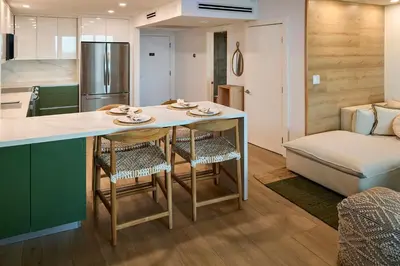 a kitchen and living room with a table and chairs at Skyline Studio at Roney Palace - 1429 in Miami Beach
