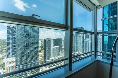 a room with windows with a view of the city at ★Luxury Studio with king bed+Free Parking+Netflix★ in Miami