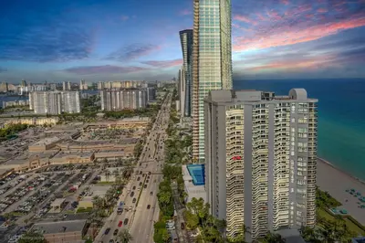 an aerial view of a city with a tall building at A Breathtaking Oceanview - High Rise Luxury Condo in Sunny Isles Beach