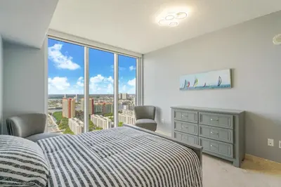 a bedroom with a bed and a large window at A Breathtaking Oceanview - High Rise Luxury Condo in Sunny Isles Beach