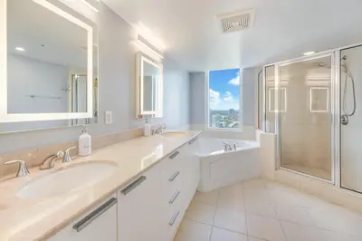 a white bathroom with a sink and a shower at A Breathtaking Oceanview - High Rise Luxury Condo in Sunny Isles Beach