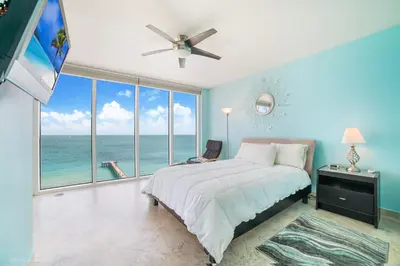 a bedroom with a bed with a view of the ocean at Balcony on the Ocean - Picture Perfect in Sunny Isles Beach