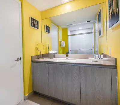 a bathroom with a sink and a mirror at Luxury Living on the Beach with Resort Amenities in Hollywood