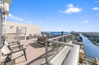a balcony with chairs and a view of the water at 2BR Ocean Penthouse - Private Terrace & Hot Tub in Hollywood