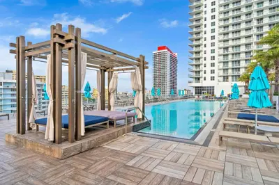 a bed by a swimming pool in a building at 2BR Ocean Penthouse - Private Terrace & Hot Tub in Hollywood