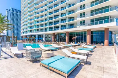 a pool with lounge chairs and a building at Luxury Penthouse 4 BDR with Resort Amenities in Hollywood
