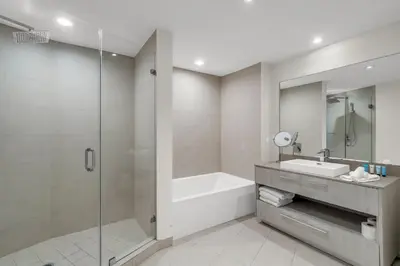 a bathroom with a tub and a sink and a shower at Luxury Penthouse 4 BDR with Resort Amenities in Hollywood