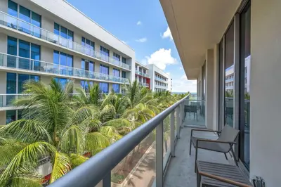 a balcony with palm trees and a building at Condo with 1 Bedroom Terrace and Hot Tub in Hollywood