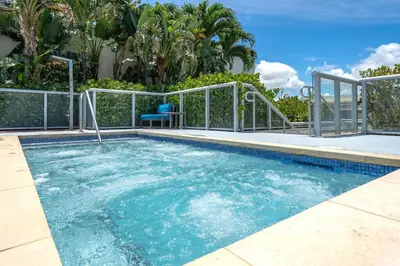 a swimming pool with a blue chair in it at Condo with 1 Bedroom Terrace and Hot Tub in Hollywood