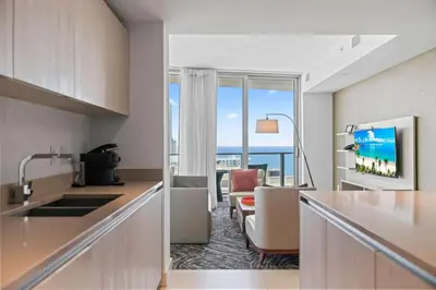 a kitchen with a view of a living room at Sunny Balcony - Beautiful Stay for 2 with Ocean Views & Resort Amenities in Hollywood