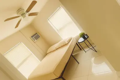 a living room with a couch and two windows at La sama Wynwood in Miami
