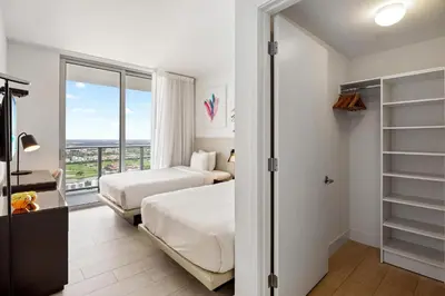 a hotel room with two beds and a balcony at 5-BR Retreat Resort & Valet Included 14 Guests in Hollywood