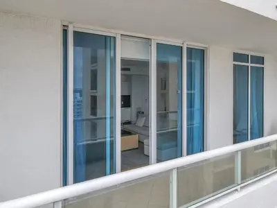 a balcony with glass doors on a building at Ritz-Carlton 2br 17th fl Penthouse Hotel Condo in Fort Lauderdale