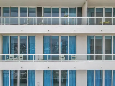 a building with tables and chairs on the balcony at Ritz-Carlton 2br 17th fl Penthouse Hotel Condo in Fort Lauderdale