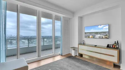 a living room with large windows with a view of the city at Ritz-Carlton 2br 17th fl Penthouse Hotel Condo in Fort Lauderdale