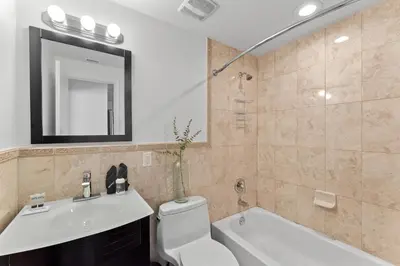 a bathroom with a sink and a toilet and a mirror at Instant Stay Ocean Drive in Miami Beach