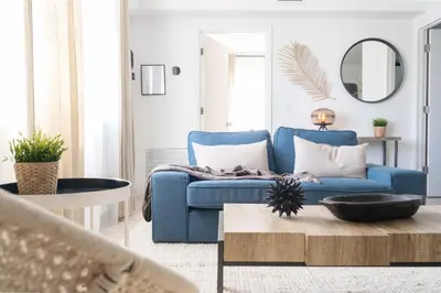 a living room with a blue couch and a table at Instant Stay Ocean Drive in Miami Beach