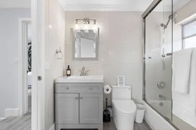 a bathroom with a toilet and a sink and a shower at Walk To Coral Gables | SLEEP 8| Free BEACH Package in Miami