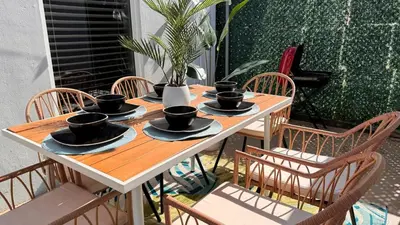 a wooden table with black cups and saucers on it at Walk To Coral Gables | SLEEP 8| Free BEACH Package in Miami