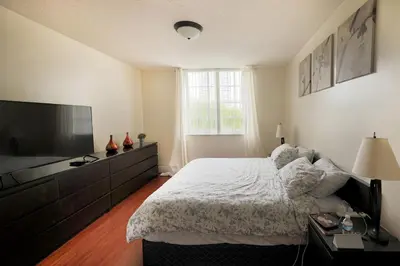 a bedroom with a bed and a flat screen tv at Apartment 2 Bedrooms at Yacht Club of Aventura in Miami