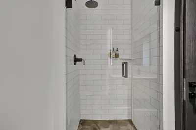 a bathroom with a shower with white tiles at 2304 Luxury Miami Studio Stunning Bay View in Miami