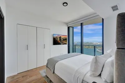a bedroom with a large bed and a large window at Miami Lux 1BR 37th Floor Bay City Views in Miami