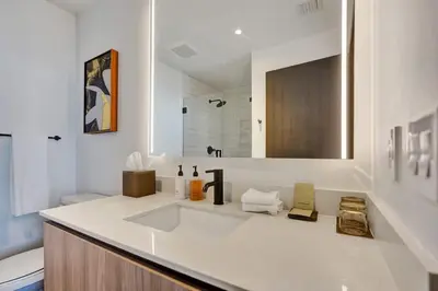 a white bathroom with a sink and a toilet at Miami Lux 1BR 37th Floor Bay City Views in Miami