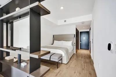 a bedroom with a large white bed and a desk at 4704 Lux Miami Studio City Bay Views in Miami