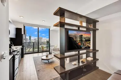 a living room with a flat screen tv on a wall at 4604 Lux Miami Studio City and Bay Views in Miami