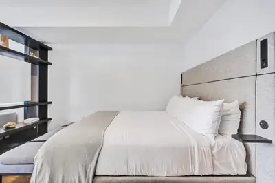 a bedroom with a large bed with white sheets and pillows at 4604 Lux Miami Studio City and Bay Views in Miami