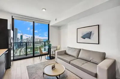 a living room with a couch and a large window at 4604 Lux Miami Studio City and Bay Views in Miami