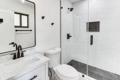 a bathroom with a toilet and a glass shower at 5 Mi to Beach Group Getaway with Yard in Miami in Miami