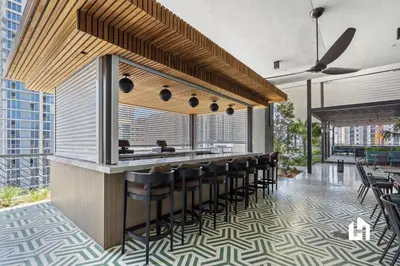 a restaurant with a bar with stools at Stylish Sky-High Condo with Pool and Gym in Miami