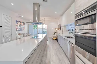 a kitchen with a white counter top and a stove at Modern Haven in Paradise w Heated Eco Pool 5B 4B in Miami