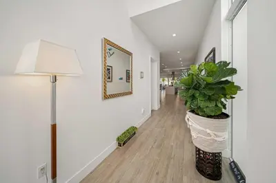 a hallway with a lamp and a potted plant at Modern Haven in Paradise w Heated Eco Pool 5B 4B in Miami