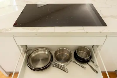 three pots and pans in a kitchen drawer at TROPICAL Villa with POOL in Private Island in Miami Beach
