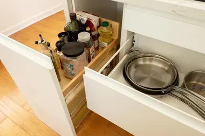 a kitchen drawer with a frying pan and bottles at TROPICAL Villa with POOL in Private Island in Miami Beach