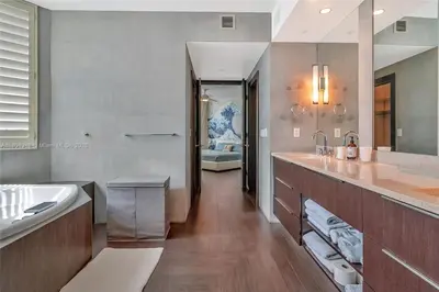 a large bathroom with a sink and a tub and a sink at High-Rise Haven by the Sea in Sunny Isles Beach