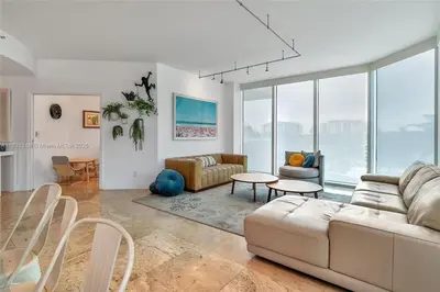 a living room with a couch and a table at High-Rise Haven by the Sea in Sunny Isles Beach