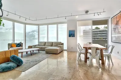 a living room with a table and a couch at High-Rise Haven by the Sea in Sunny Isles Beach