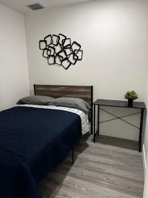 a bedroom with a bed and a side table at Santuaria Hollywood in Hollywood