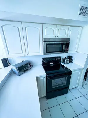 a kitchen with a stove and a microwave at Shine Suites Duplex Bay7A in Miami Beach