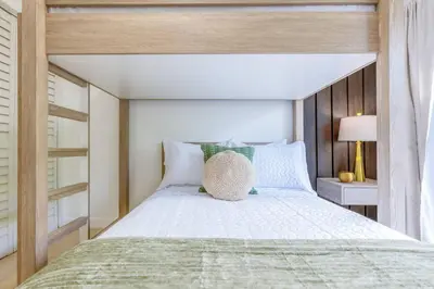 a bedroom with a large bed with a wooden headboard at Walk to Coral Gables| Beautiful Property| Sleeps 8 in Miami