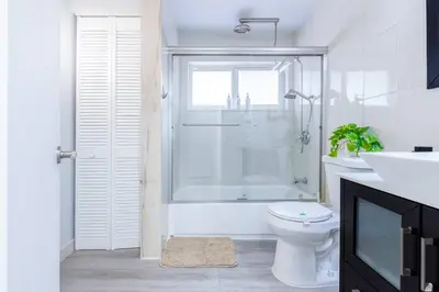 a bathroom with a shower and a toilet and a sink at Walk to Coral Gables| Beautiful Property| Sleeps 8 in Miami
