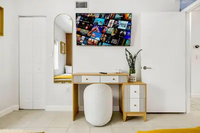 a desk and a chair in a room with a mirror at Prime Miami Retreat | Sleeps 12 | Parking, BBQ! in Miami