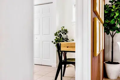 a room with a table and potted plants at Beachy Living |Sleep 8 Best Location | BBQ & Patio in Miami