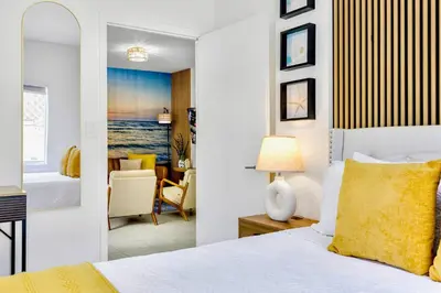 a bedroom with a bed and a living room at Beachy Living |Sleep 8 Best Location | BBQ & Patio in Miami