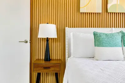 a bedroom with a bed and a lamp on a night stand at Tropical | 8PPL | Top Location | Parking | Laundry in Miami